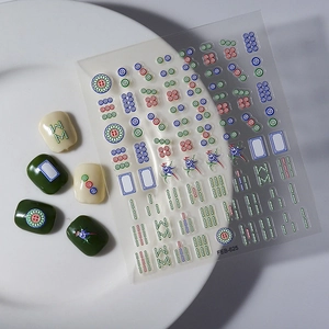 3D embossed mahjong nail stickers featuring tiles like Red Dragon on white display plate