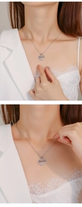 Close-up of silver heart-shaped MAMA necklace with zircon stones on a female model