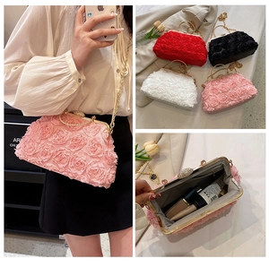 Detailed view of 3D rose flower evening clutch with metal clasp and chain strap