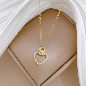 Macro detail of gold-plated double heart pendant necklace with shimmering crystal pavé