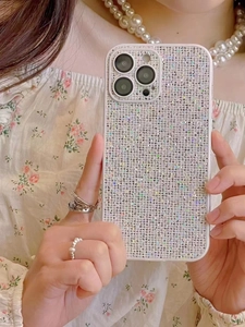 Close-up of luxury sparkling rhinestone phone case for iPhone held by a model