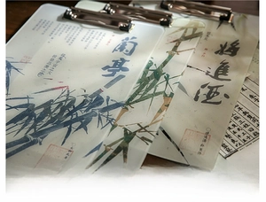 Macro detail of Chinese calligraphy acrylic clipboard with metal clip and ink bamboo pattern