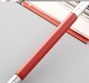 Close-up of red shimmer dual-ended makeup brush with silver metal connectors