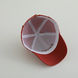 Internal view of a red toddler baseball cap featuring six-panel structure and sweatband