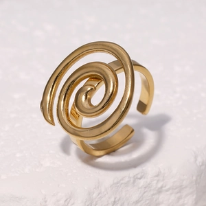 Adjustable 18k gold plated stainless steel spiral ring on a white stone pedestal