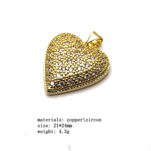 Detail showing heart-shaped gold-plated copper pendant with micro-set zircon accents