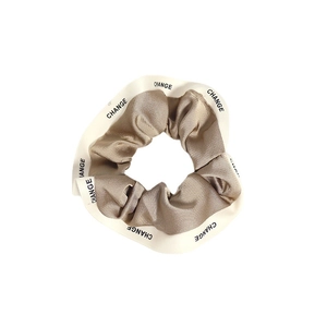 Elegant champagne silk satin scrunchie with white 'CHANGE' letter print trim for women