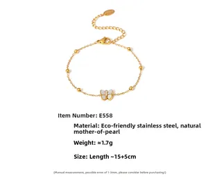 Detail view of gold butterfly bracelet with white mother of pearl and tiny gold beads