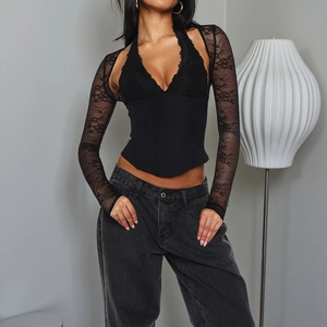 Detail of black lace long sleeves and slim fit corset top with halter neck design