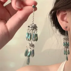 Elegant silver flower earrings with green crystal tassels in a Korean style design