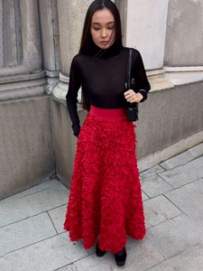 Detailed macro view of 3D petal texture on a long red evening A-line skirt with high waist
