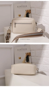Detail of lychee pattern cream PU leather bag with wide colorful woven strap
