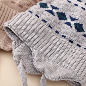Close-up of the ribbed knit edge and detailed geometric pattern on a winter earflap hat