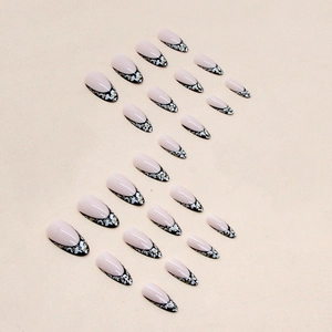 Almond shaped french leopard print false nails with silver glitter on beige background