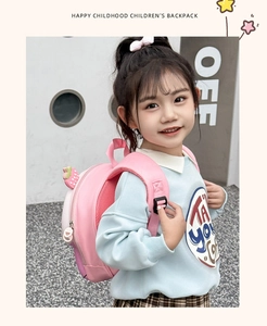 Pink strawberry kids backpack with cute cartoon zipper detail shown on a young girl