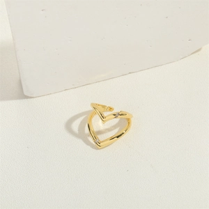 Minimalist double heart gold open ring with small diamond accent on textured surface