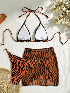 Three-piece tiger print bikini set with matching mesh sarong and beach accessories