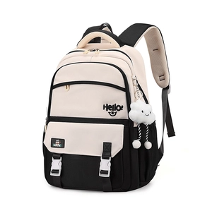 Detail view of contrast color backpack featuring plush pendant and multi-pocket design