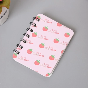 Close-up of pink A7 spiral notebook with cute strawberry and Korean pattern design