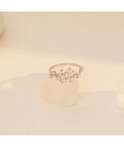 Macro shot of leaf-shaped silver ring with sparkling marquise-cut cubic zirconia crystals