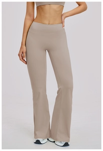 Close-up of high-waist slimming beige yoga flare pants with tummy control compression