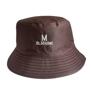 Detail of coffee brown bucket hat showing fabric texture and white St.Michel embroidery