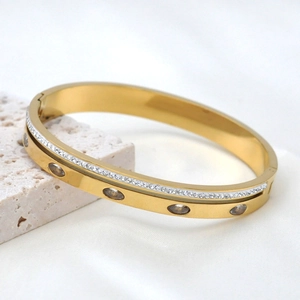 Golden 18k stainless steel bangle with pavé zircons and oval champagne gemstones