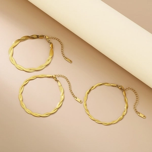 Detailed view of three gold braided snake bone bracelets with adjustable s.steel chain links