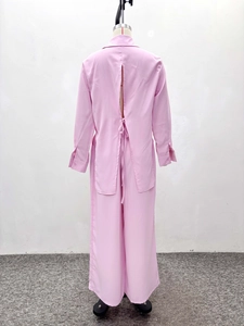 Detail of the pink shirt back featuring a stylish split design and bow-tie closure