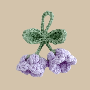 Handmade crochet lily of the valley keychain with purple buds and green leaves
