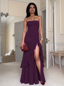 Elegant purple strapless ruffled maxi dress with high slit and stylish red clutch bag