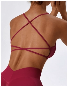 Close-up of seamless yoga bra with cross-back straps and high-waist leggings in wine red