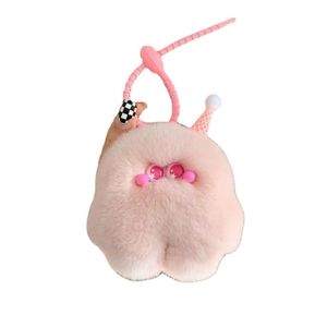 Pink plush monster keychain with ice cream hat and silicone lanyard on white background