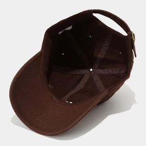 Detail view of cotton baseball cap interior with stitching, sweatband and metal buckle