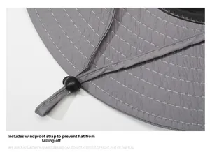 Detail of gray sun hat with adjustable black windproof drawstring and reinforced stitching