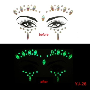 Detailed view of luminous face jewel stickers showing glow-in-the-dark effect for party