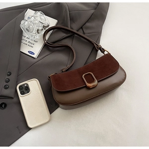 Detailed view of dark brown faux suede and PU leather shoulder bag with vintage metal buckle