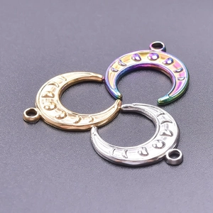 Three moon pendants in gold, silver, and rainbow steel finishes with textured surface