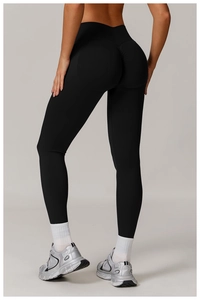 Detail of high-waist black yoga leggings featuring V-shaped seam and ruched butt-lift design