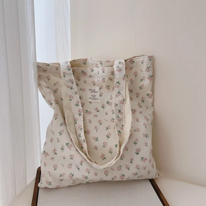 Close-up of floral cotton tote bag with vintage pattern and stitched fabric label