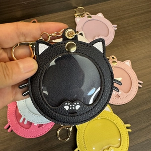 Close-up of cat-shaped PU leather badge holder with transparent window and metal clip