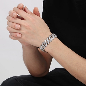 Close-up of a silver iced-out cuban link bracelet on wrist with sparkling rhinestones