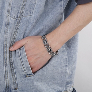 Macro detail of men's vintage punk skull bracelet in silver-tone stainless steel