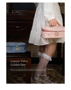 Pink and blue velvet makeup bags with gold star patterns and star-shaped metal zippers
