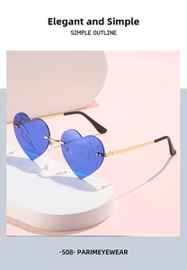 Detail of blue heart-shaped rimless sunglasses with lightning pattern etched on lenses