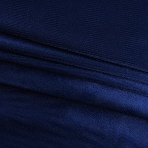 Close-up of dark blue satin fabric texture with elegant sheen and fine weaving details