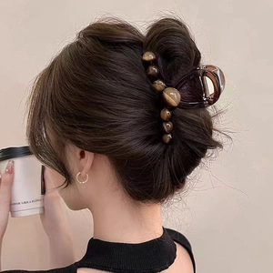 Large amber gradient resin shark hair clip for women shown on model hair updo