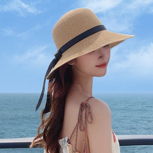 Women's wide brim straw sun hat with black ribbon bow for summer beach vacation