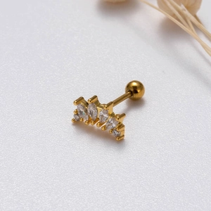 Macro shot of gold ear stud with marquise and round cubic zirconia cluster and ball back
