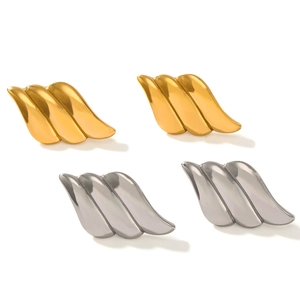 Modern gold and silver wing-shaped textured earrings set with a sleek metallic finish
